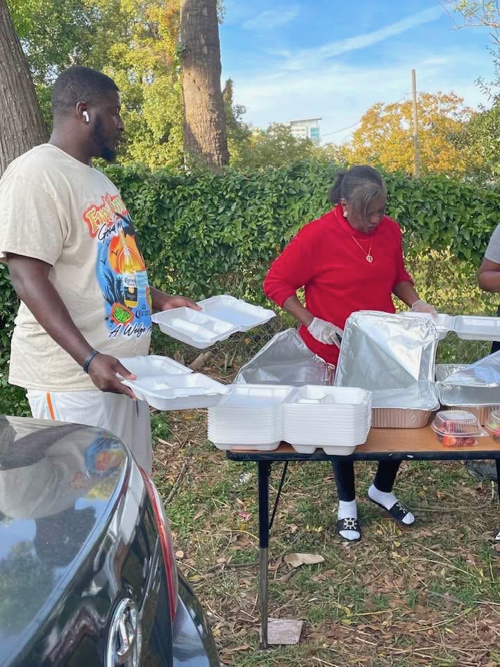 Volunteers packing meal trays for distribution