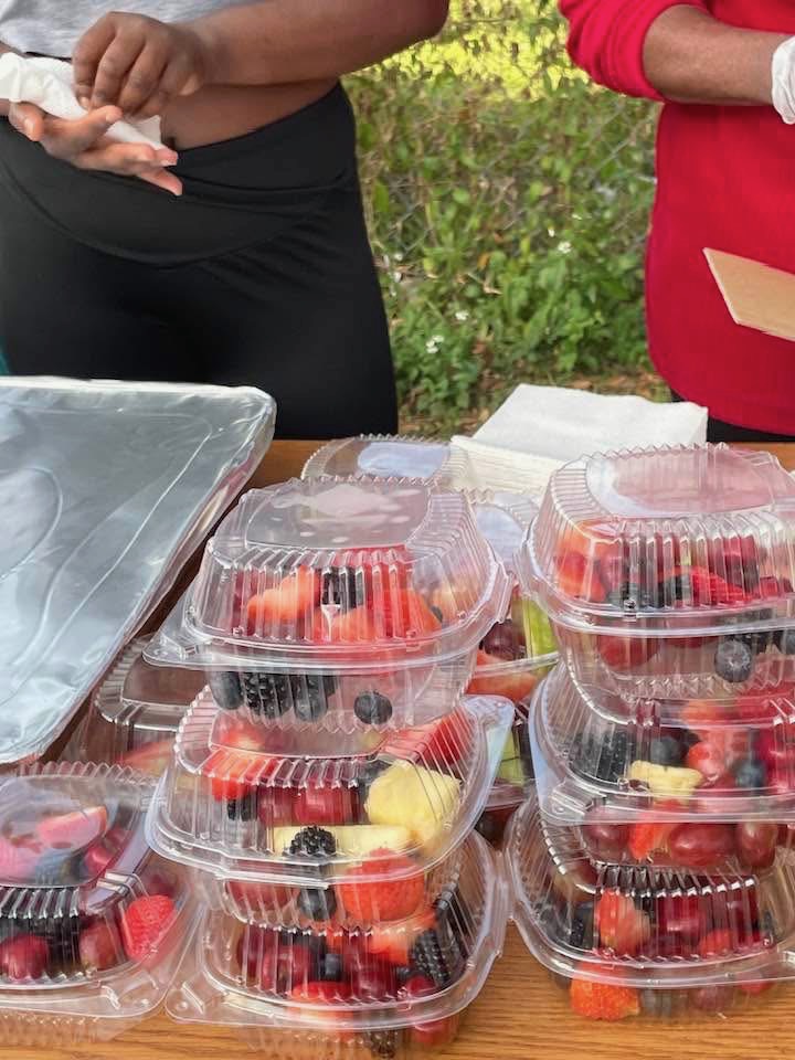 Stacks of fresh fruit cups prepared by volunteers